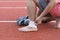 Man applying compression bandage onto ankle injury of a football player