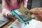 Man applying credit bank card to pos terminal closeup