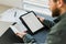 Man applying for visa on tablet and holding passport, Canada.