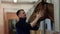 The man approaches his horse in the stables.