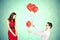 Man approaching woman giving her red heart shape balloons