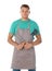 Man in apron with barbecue utensils on background