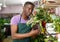 Man in apron checking potted plants