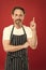 Man in apron. Confident mature handsome man in apron red background. He might be baker gardener chef or cleaner. Good in