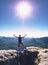 Man with arm outstretched celebrating sunset in mountains