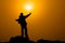 Man with arms extended toward heaven at sunrise ,success or prayer concept