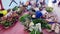 Man arranges flowers on a concrete slab to be sold during the celebration of All Souls Day after Covid 19 social restrictions had