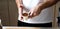 Man arranging coffee ground powder into portafilter basket at home