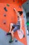 Man on artificial exercise climbing wall