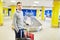 Man as a passenger is waiting at the baggage handling system