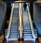 Man ascending an escalator from a subway