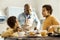 Man asking his sons not to swear in the kitchen while eating.