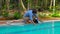 Man assembles a pool vacuum cleaner. Providing service and maintenance of the pool