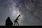 Man with astronomy telescope looking at the stars.