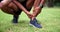 Man, athlete and ankle pain on sport field for body workout with hands and anatomy outside. Exercise, wellness and black