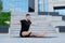 Man athlete in black sportswear practices yoga exercises, stretches, fitness, lotus position, warrior pose