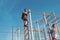 Man athlete climb on top and woman split leg. Sport couple training in metal jungle gym. Sportsman and sportswoman at