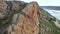 Man athlete climbing on the high rock