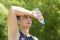 Man athlete received sun, heat stroke, headache. boy with bottle of water in nature on hot day