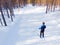 Man athlete trains cross-country skiing in winter on snow covered track in forest