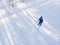 Man athlete trains cross-country skiing in winter on snow covered track in forest