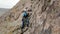 Man athlette climbing on the high rock