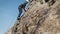 Man athlette climbing on the high rock
