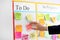 Man attaching sticky note to scrum task board in office