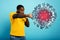 Man attacks with a punch the coronavirus. Blue background