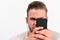 Man with attentive face looks at mobile phone. Entertainment concept