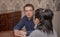 A man attentively listens to a woman sitting at a Desk in the office. Concept, psychological help, problem solving training, famil