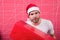 Man attractive santa claus carry big box. Christmas gift exchange. Christmas holiday celebration. Man handsome unshaven