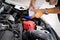 Man or auto mechanic worker hands add distilled water to car battery. Checking and maintenance service the car battery