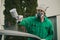 Man with automotive air spray gun in action during the restoration of a vintage car. Applying first base layer of paint onto bare