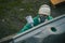 Man with automotive air spray gun in action during the restoration of a vintage car. Applying first base layer of paint onto bare