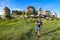 A man on the background of a picturesque view of the Bakhchisarai sphinxes. Bakhchisarai. May 2021