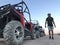 The man on the background of a sports car is buggy. ATV desert tour in Egypt. Outdoor activities and adventures in the stone