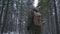 A man with a backpack carries a sleigh through the winter forest. Hiking in the winter forest.