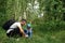 A man with a backpack, a father and his son on a hike, walking during walks in the woods. Family life, pastime with the family,