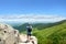 Man with backpack hiking in mountains on a summer vacation trip.