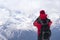 Man with backpack looking towards the slopes and peaks of the mo