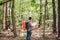 Man with Backpack and map searching directions in wilderness area. Tourist with backpack using map in forest. concept