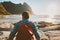 Man with backpack relaxing on Kvalvika beach enjoying ocean view travel lifestyle