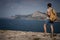 Man with backpack relaxing outdoor Sea and Rocks coastal on background Freedom Lifestyle concept