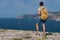 Man with backpack relaxing outdoor Sea and Rocks coastal on background Freedom Lifestyle concept