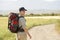 Man With Backpack Walking On Country Road