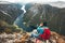 Man backpacker using smartphone relaxing on mountain top