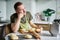 Man baker thinking at kitchen with dough balls on wooden board