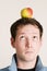 Man balancing apple on head