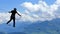 Man balancing on a rope in the climbing park with a view of the Alps